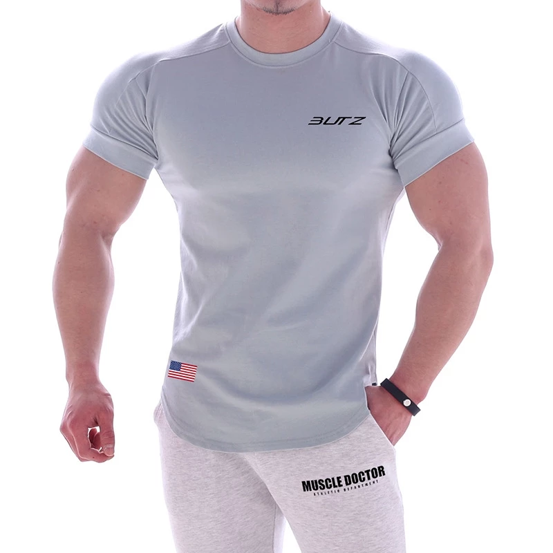 เสื้อยืดกีฬาผู้ชายฤดูร้อนซับเหงื่อและระบายอากาศ 2021 ใหม่ผ้าฝ้ายแขนสั้นออกกำลังกายด้านบนชุดฝึกวิ่ง